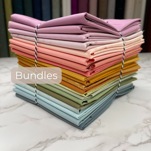 Two bundles of rainbow colored fabrics