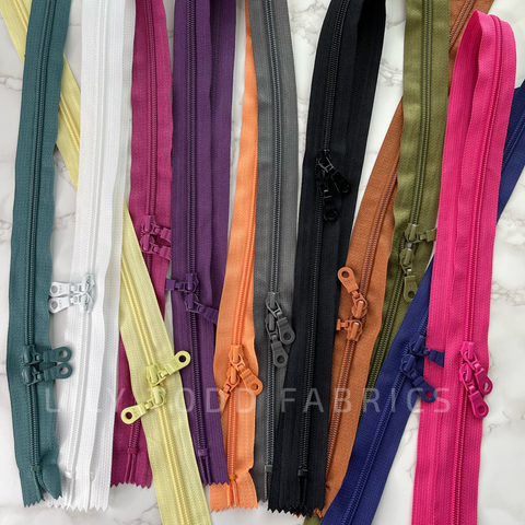 A group of 30 inch double pull zippers for bag making.