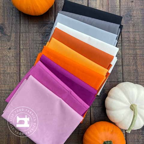 purple, orange, white, gray, and black fabrics make up this halloween inspired bundle.